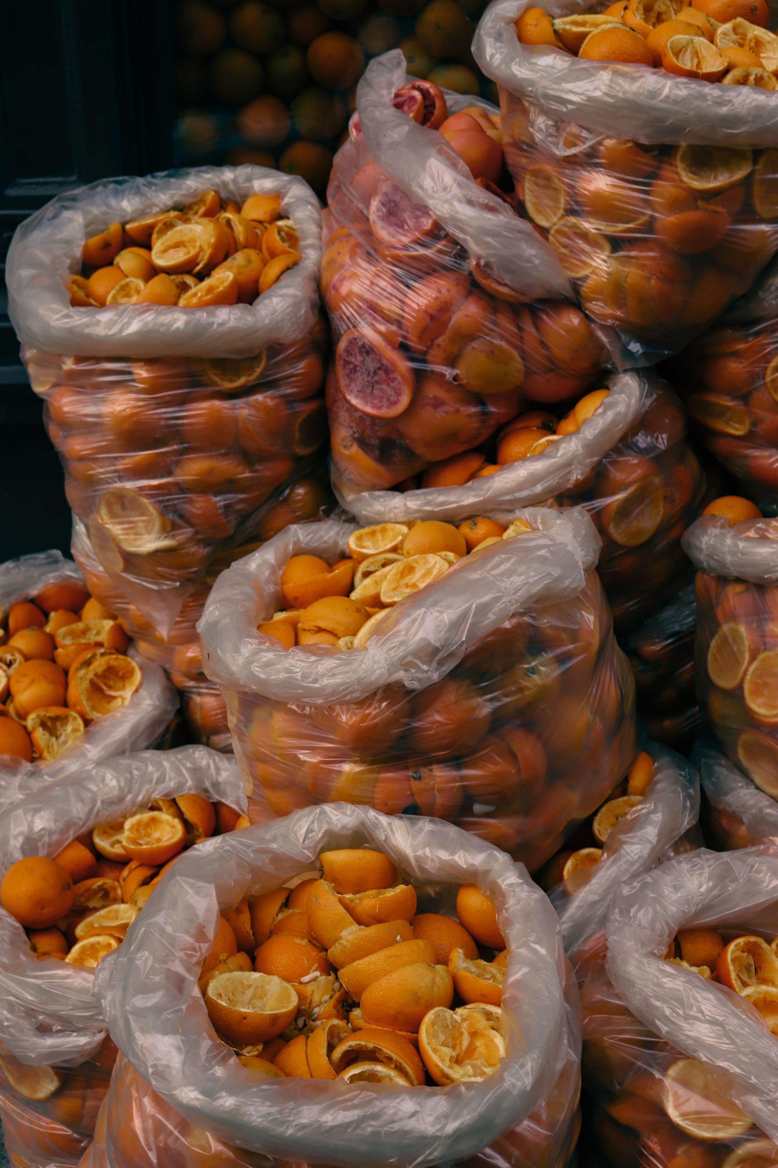 Bags of squeezed orange peels from a juice bar
